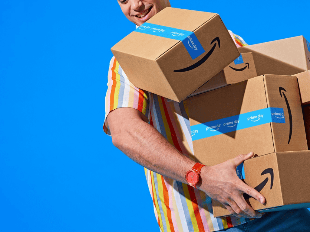 An image depicting a man carrying Amazon boxes
