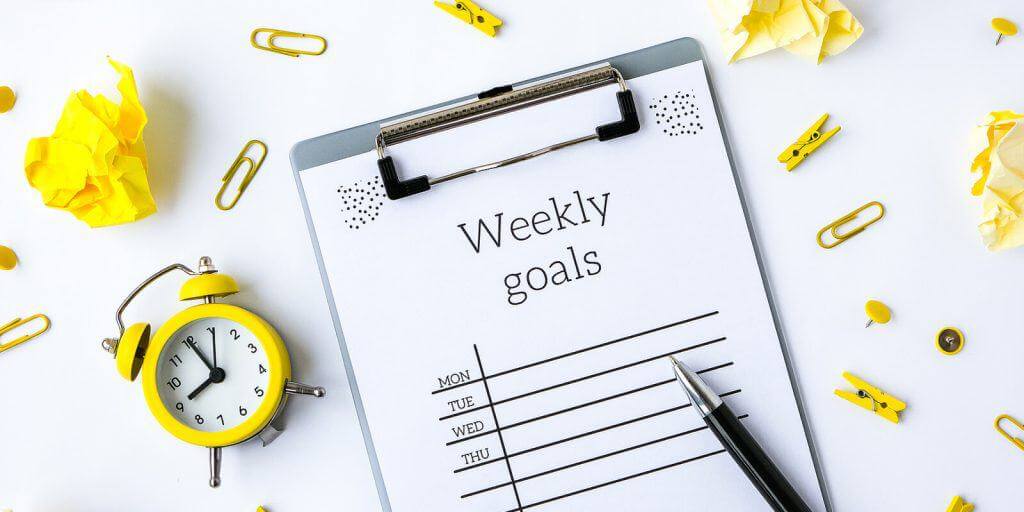 An image showing a clipboard with a weekly goals sheet